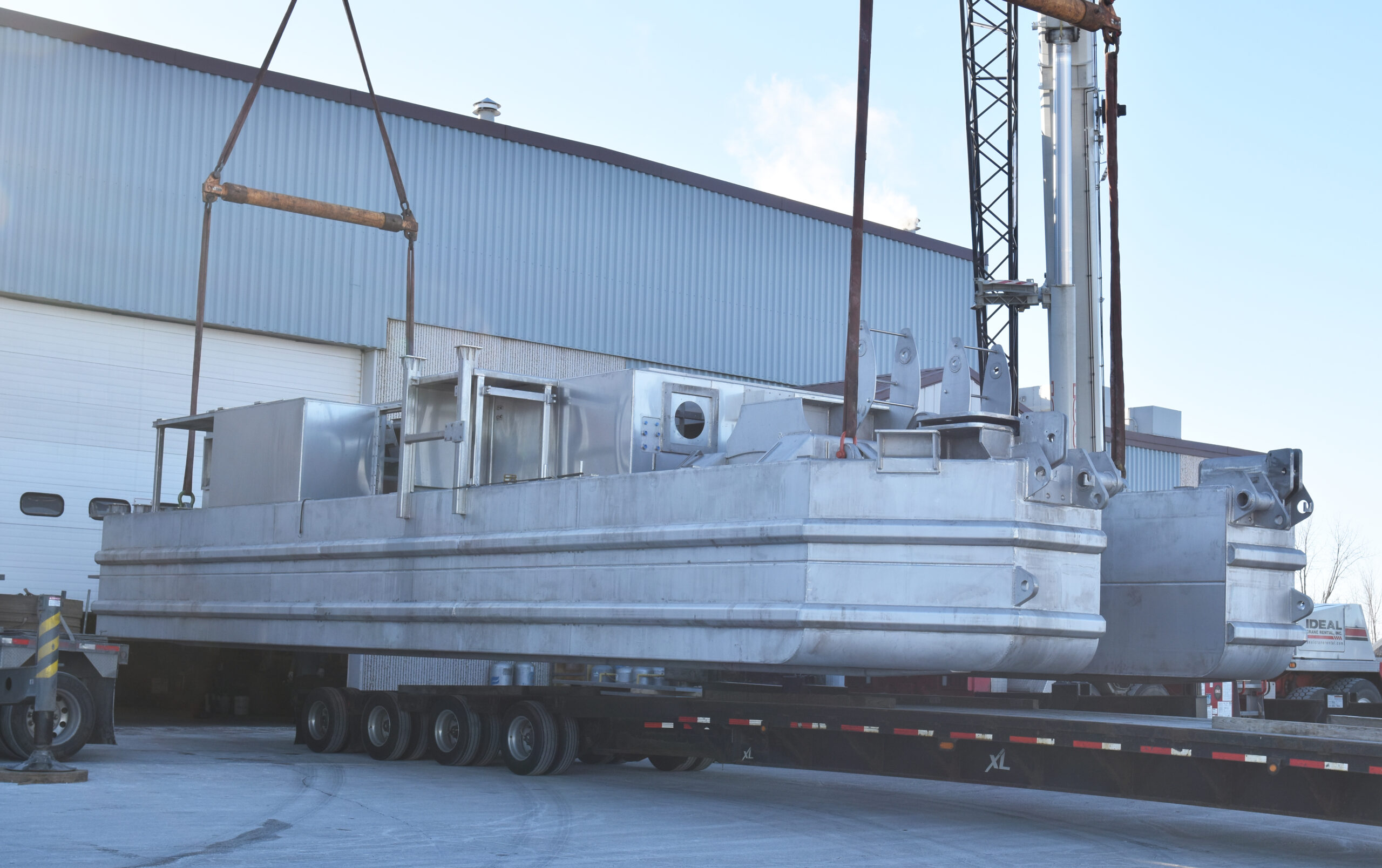 Mining dredge on a crane to be delivered to the customer.