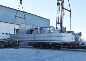 The mining dredge leaves the Bassett Mechanical manufacturing facility en route to the customer.